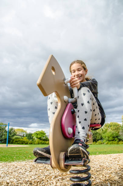 istock Girl playing on a horse swing 1278501115