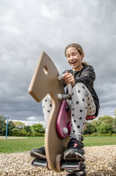 istock Girl playing on a horse swing 1278501152