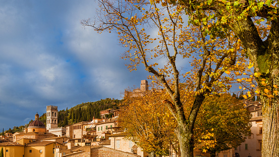 View of the city ancient buildings with autumnal leaves and beautiful clouds