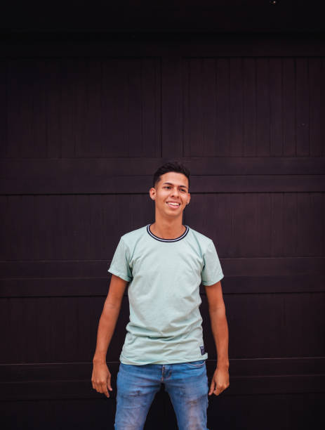 istock happy young man black wall light blue shirt 1278503434