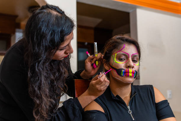 istock woman putting makeup on another woman 1278504001