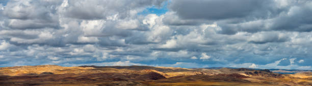 istock Cloudy sky over yellow steppe hills 1278504016