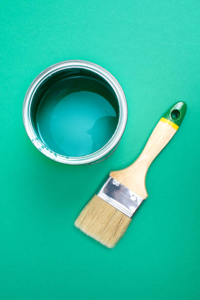 istock Open paint enamel cans on green turquoise palette samples. 1278506645