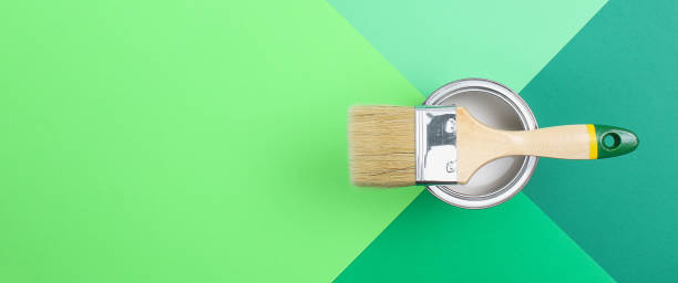 istock Open paint enamel cans on green palette samples. 1278506660
