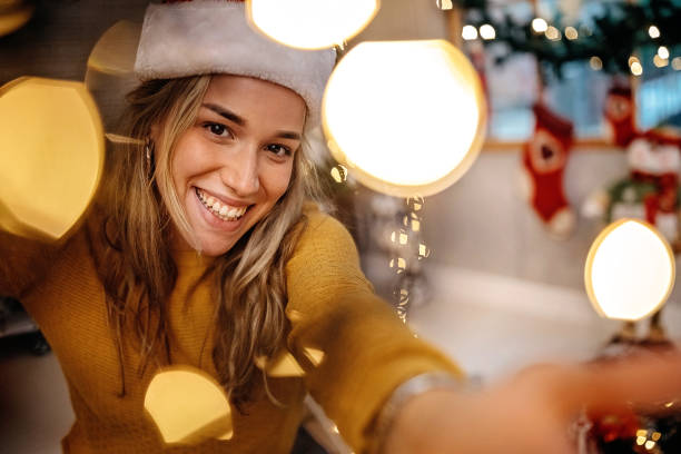 istock Women doing selfie at home, wearing Santa hat 1278507707
