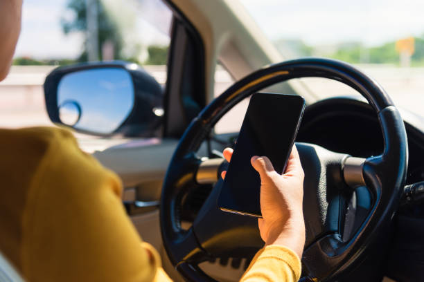 istock woman inside a car and using a hand holding mobile smartphone 1278509486