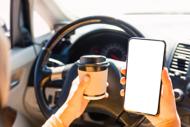 istock woman drinking hot coffee takeaway cup inside a car and using smartphone 1278509503