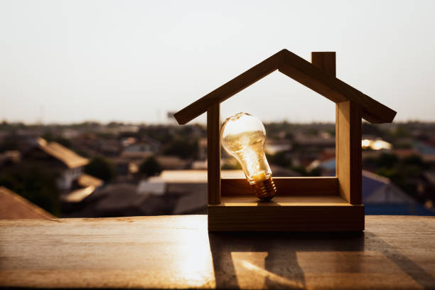 istock Light bulb with wood house on the table, a symbol for construction, Creative light bulb idea, power energy or business idea concept ecology, loan, mortgage, property or home. 1278509657