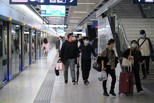 Wuhan/China-Oct.2020: people in face mask to prevent coronavirus, walking at subway platform