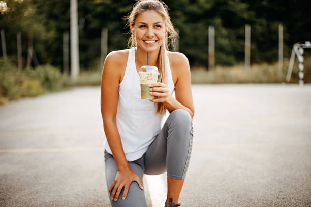 Women drinking smoothie on court