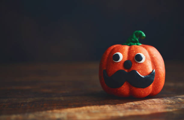 istock Cute pumpkin with handmade mustache. Halloween Background 1278513498