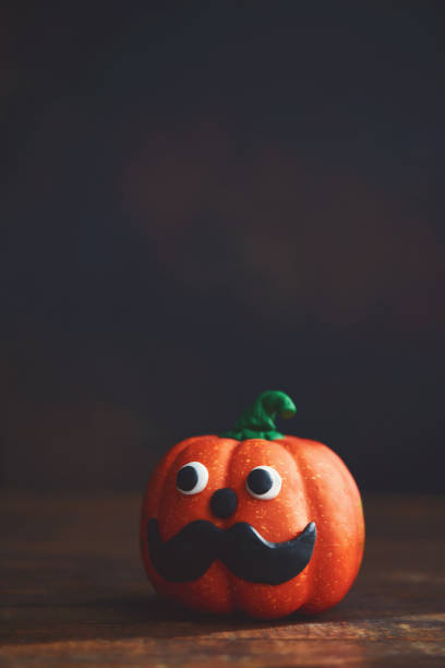 istock Cute pumpkin with handmade mustache. Halloween Background 1278513500