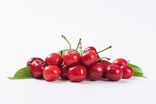 Freshly picked heap of cherries - isolated on white background with soft shadow + clipping path