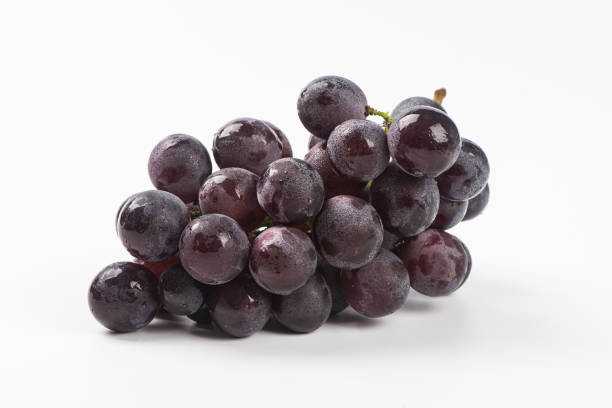 istock a bunch of purple grapes isolated on white background 1278515277