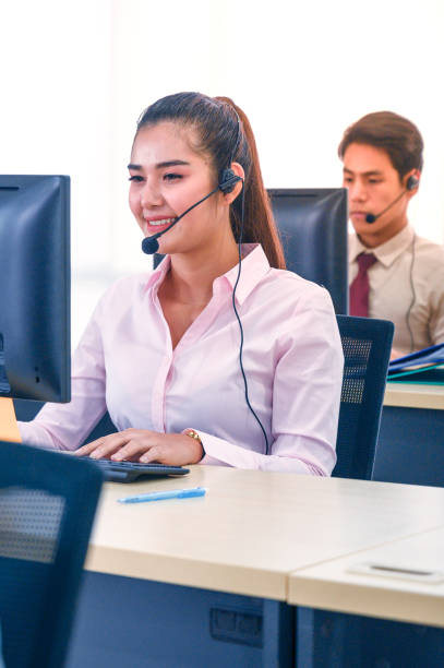 istock Young customer service women agent with headsets and computer working at office. 1278515950