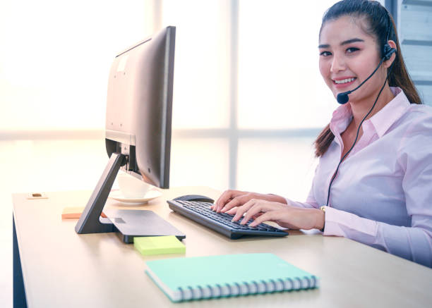 istock Young customer service women agent with headsets and computer working at office. 1278515973