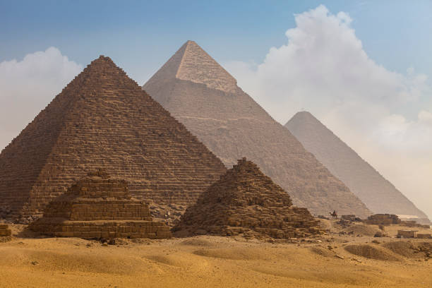istock The camel caravan is in front of the Egyptian pyramids. 1278518386