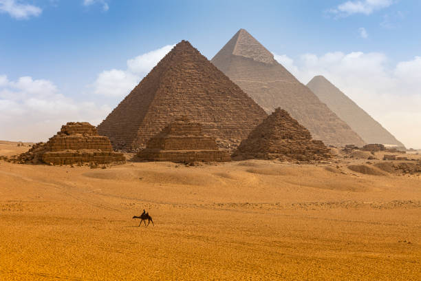 istock The camel caravan is in front of the Egyptian pyramids. 1278518437