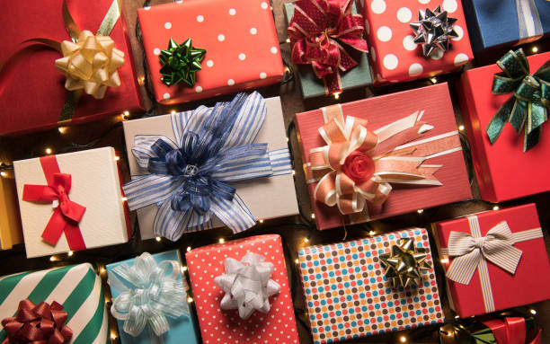 istock Christmas decoration light and gift boxes on wooden background top view with copy space for frames, presents, and festive Christmas decoration 1278519244