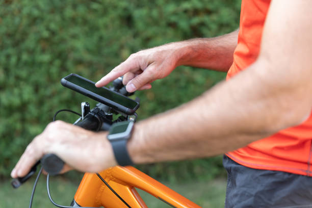 istock Close-up Of Human Hand Pointing At Smart Phone On Bicycle 1278519468