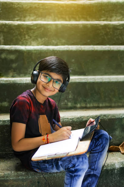 istock Indian / Asian Little boy studying online using mobile phone at home 1278521224