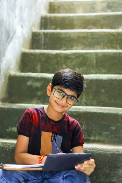 istock Indian / Asian Little boy studying online using mobile phone at home 1278521236