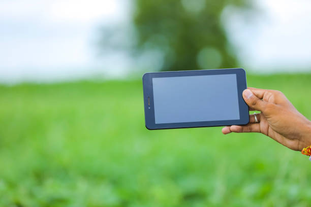 istock Technology and people concept, Young indian agronomist with tablet at field 1278525407