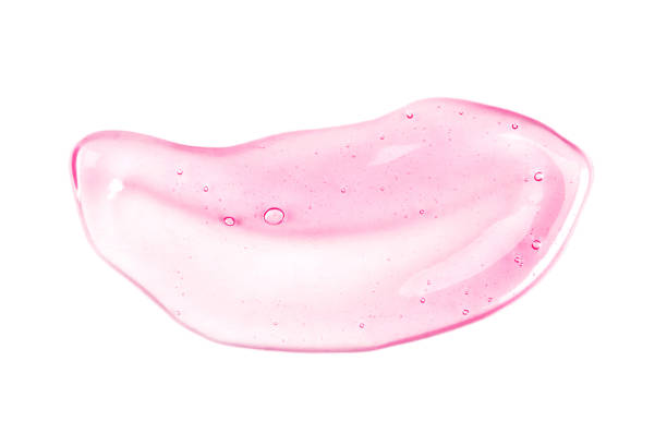 Pink transparent smear of liquid moisture essence serum for face on white background isolated. Hydrating Hyaluronic acid. Antibacterial gel. Cosmetic products for makeup and skin care. Cosmetology. Pink transparent smear of liquid moisture essence serum for face on white background isolated. Hydrating Hyaluronic acid. Antibacterial gel. Cosmetic products for makeup and skin care. Cosmetology. shower gel stock pictures, royalty-free photos & images
