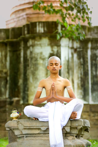 istock indian priest child doing yoga at park 1278527386
