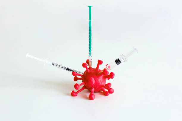 istock Injecting different vaccines into a pathogen like viruses and bacteria. Syringes with vaccines injected in corona virus on the white background. 1278527415