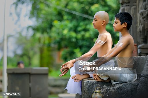 istock indian priest child doing yoga at park 1278527476
