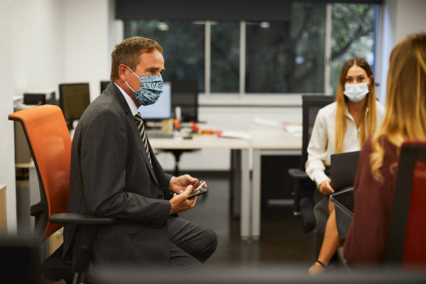 istock Social distancing business meeting in a small office. 1278529186