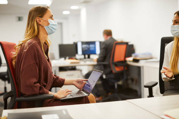 istock Two business colleagues share work in an office. 1278529210