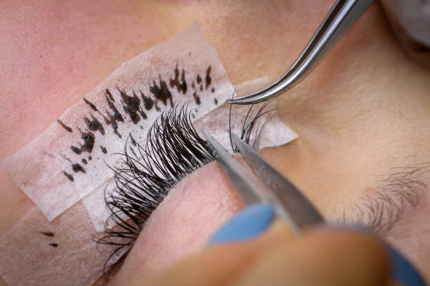 istock Eyelash extension procedure, woman eye with Long eyelashes 1278537761