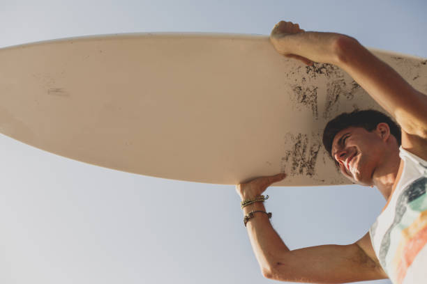 istock Young man going to the sea with his surfboard 1278541056