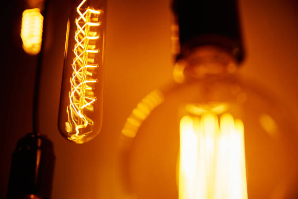 istock Set of a vintage light bulb on orange background, soft focus. Glowing edison bulb 1278542320