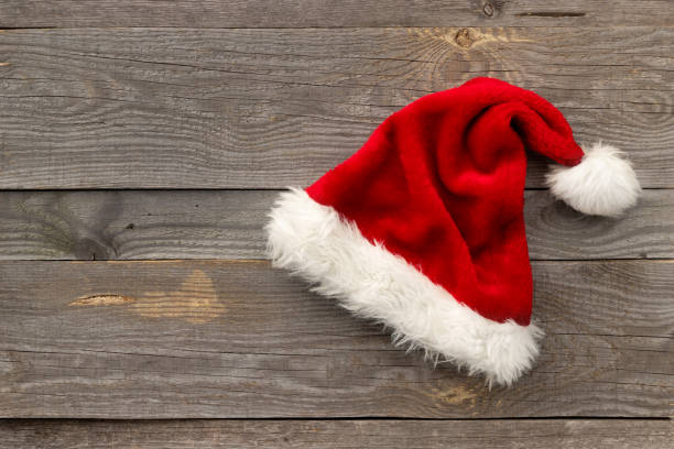 istock Red Santa hat on old wooden background 1278542373