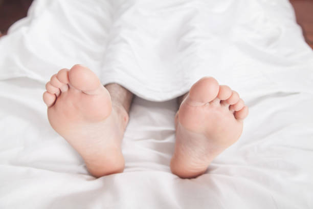 istock Male feets on bed in morning. 1278544456