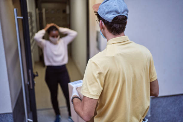 istock Responsible delivery man wearing protective face mask and gloves while deliver a package to a customer 1278547230