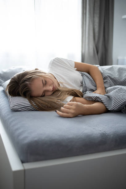 istock Pretty, young woman sleeping in her bed 1278547392