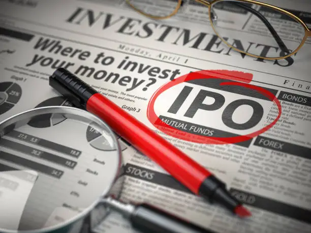 Photo of IPO Initial public offering concept. Where to Invest concept, Investments newspaper with loupe and marker.