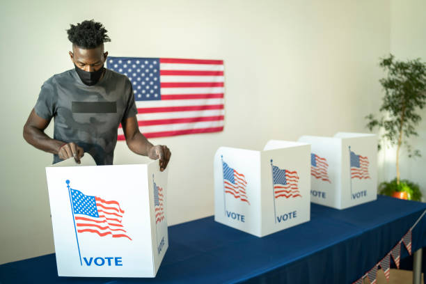 istock Young volunteer preparing the voting booths for Election Day 1278547886