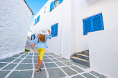 Little girl walking on a greek street