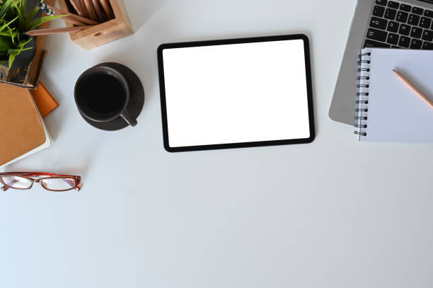 istock Designer workspace tablet with white screen, note book, office supplies and coffee cup for graphics display montage. 1278551256