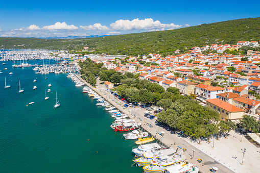 Marina and seafront in town of Punat on Krk island, Kvarner bay, Croatia, aerial view from drone