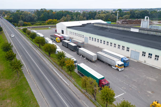 istock MINSK, BELARUS - SEPTEMBER 2020:  factory on processing of a tree top view. Trucks are waiting to load. 1278553034