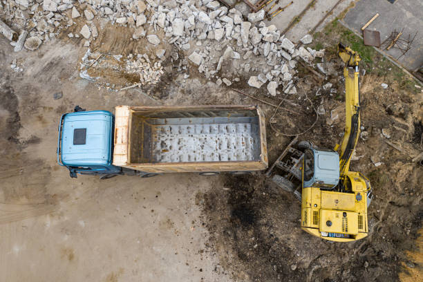 istock excavator loads sand in a truck top view. 1278554694