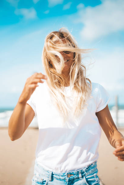 istock Woman on the beach with a wind 1278554744