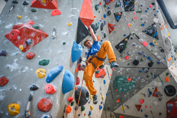 istock Low Angle View of Strong Male Athlete Scaling Climbing Wall 1278555578