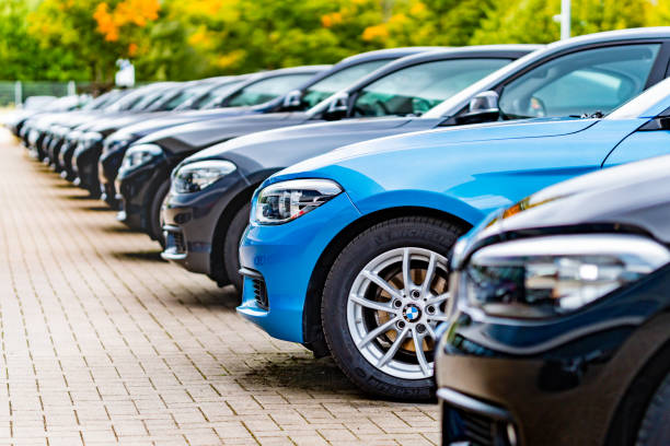 a row of used bmw cars parked at a public car dealership in hamburg, germany - automobile industry metal industry in a row gear imagens e fotografias de stock